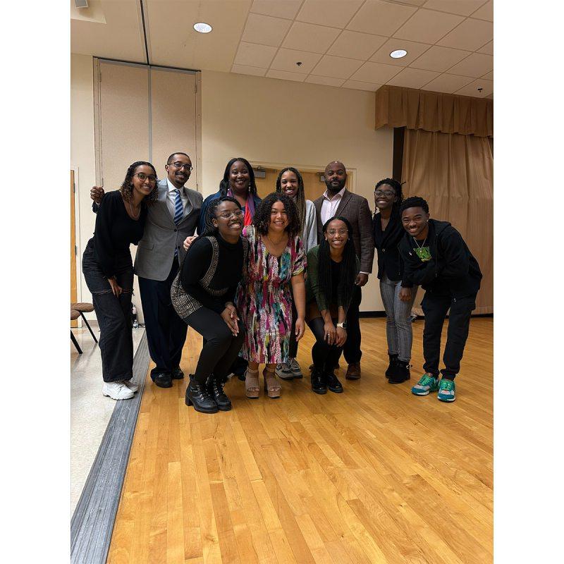 A group photo with students and guest speakers at a mental health summit.